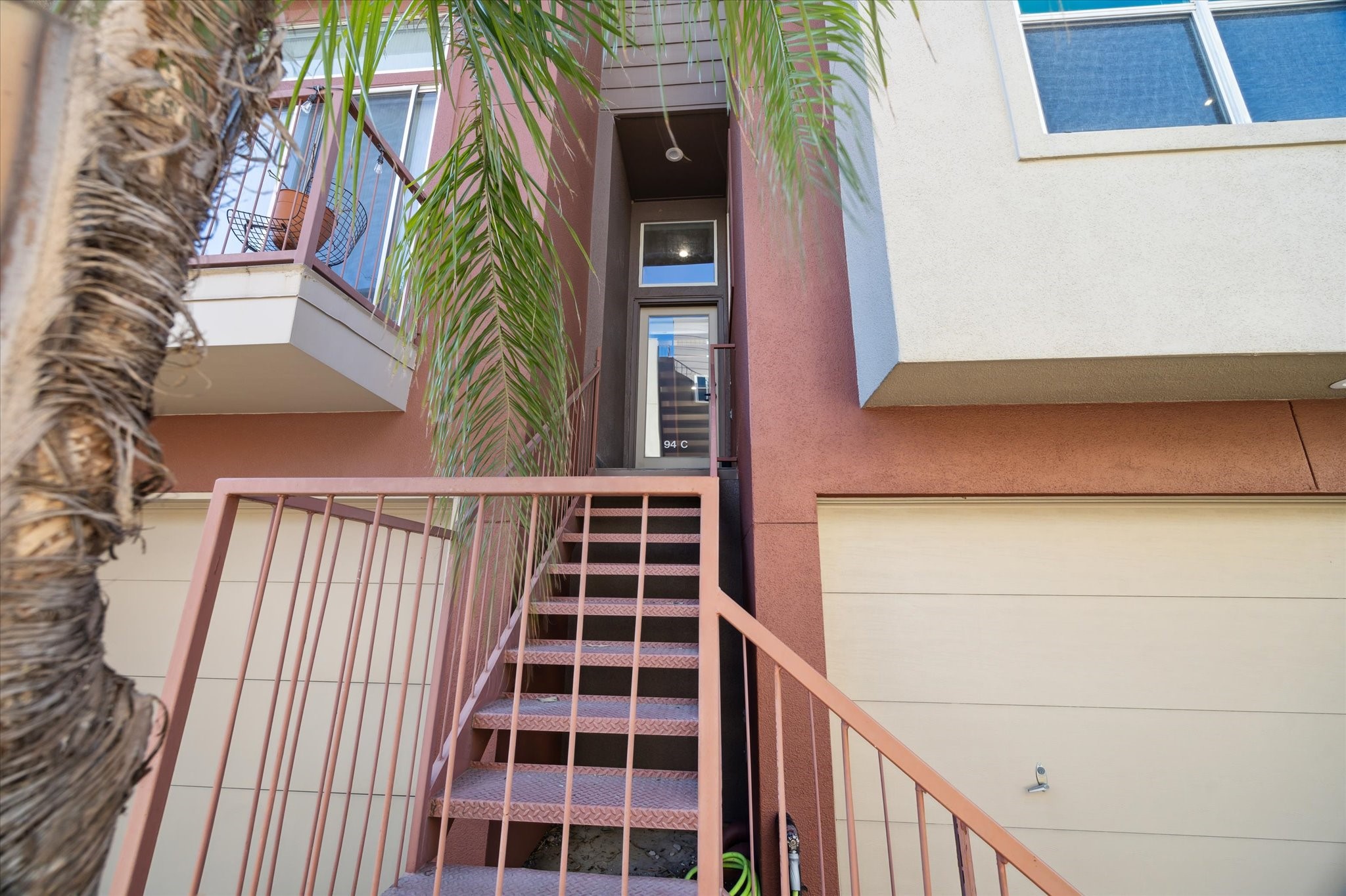 94 Drew Street, Unit C Houston, TX 77006 - Photo 3 of 29 Striking steel stairs lead to front glass panel door entrance.