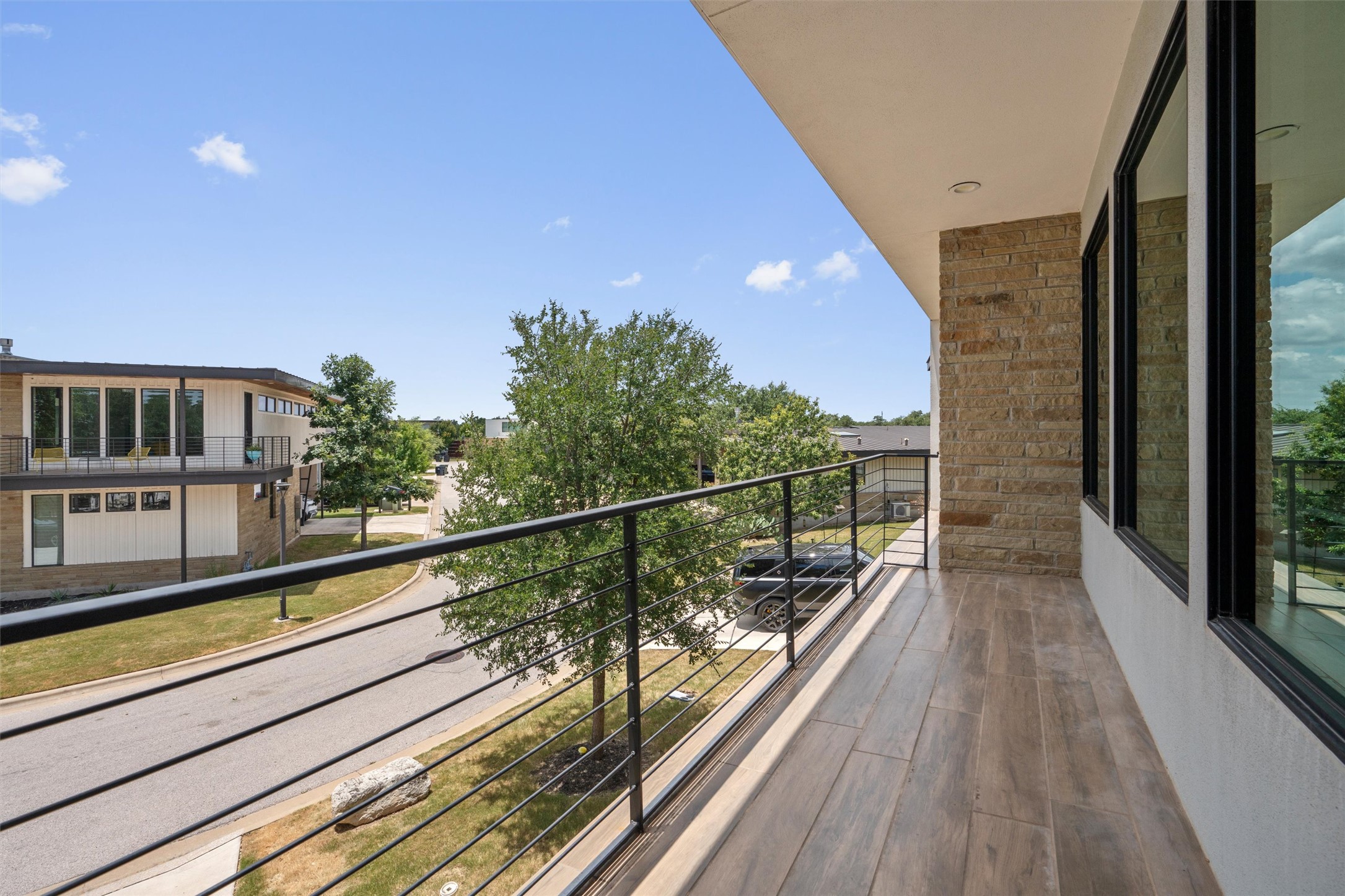 408 Starlight Village Loop Leander, TX 78641 - Photo 27 of 40 Step onto the balcony, offering treetop views and sleek architectural lines.