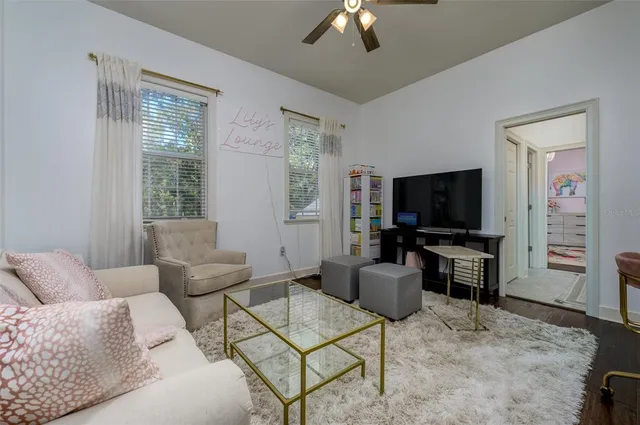 an aerial view of a house with a yard and large trees