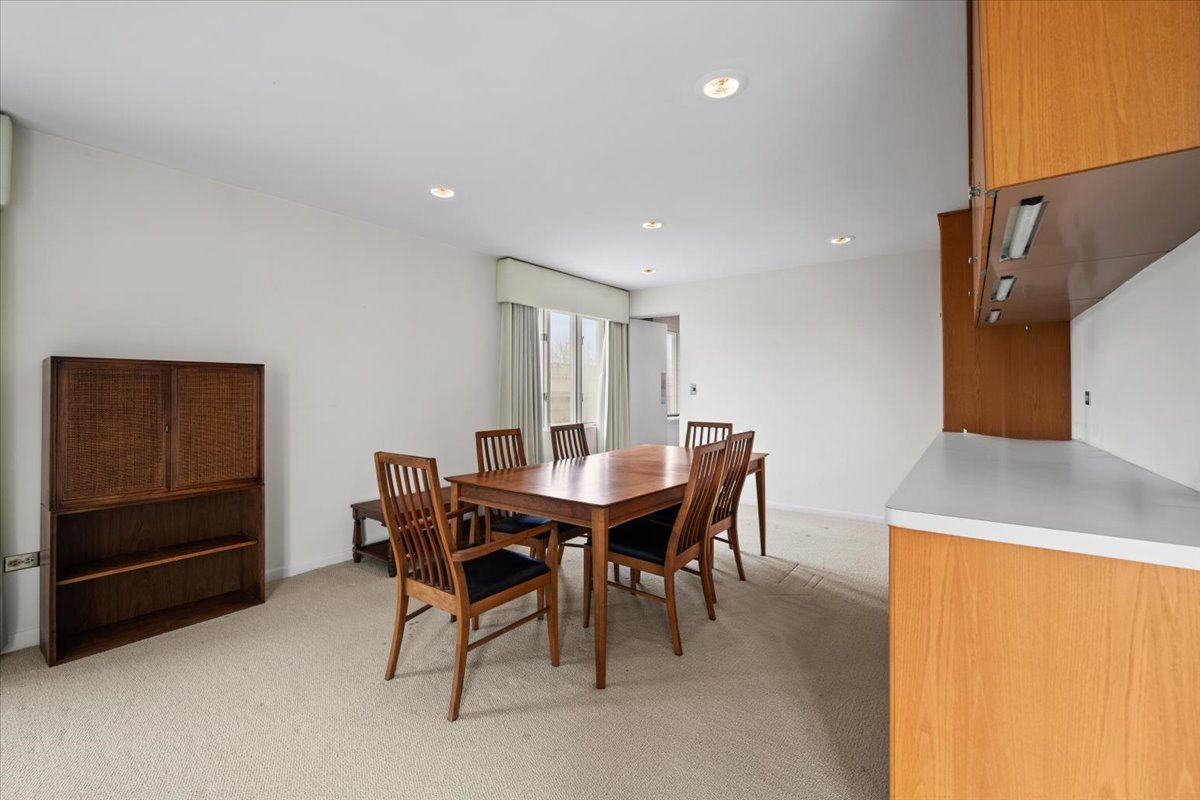 1730 West Galena Boulevard, Unit 402E Aurora, IL 60506 - Photo 11 of 26 a view of a dining room with furniture and a chandelier
