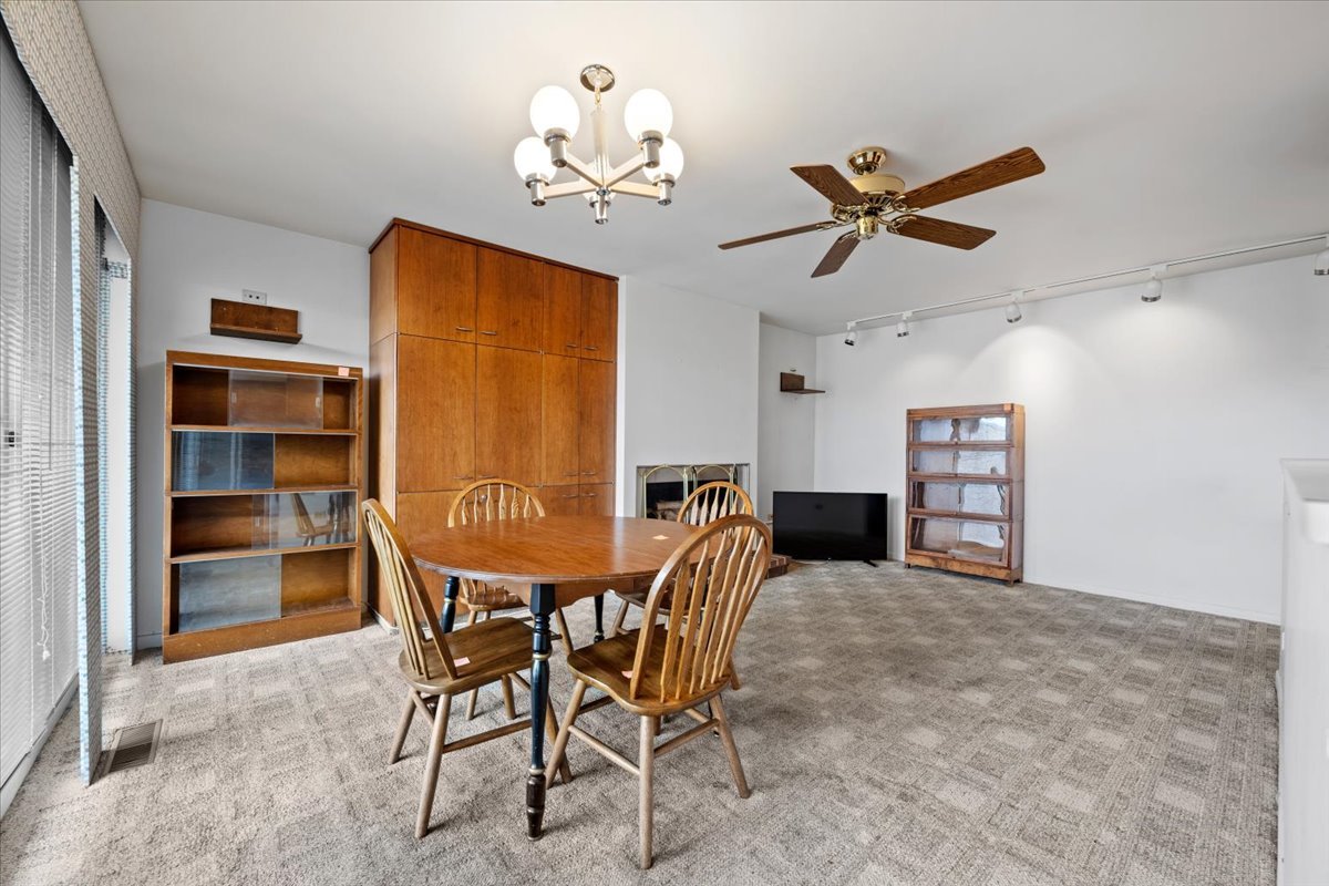 1730 West Galena Boulevard, Unit 402E Aurora, IL 60506 - Photo 16 of 26 a view of a dining room with furniture and a chandelier fan