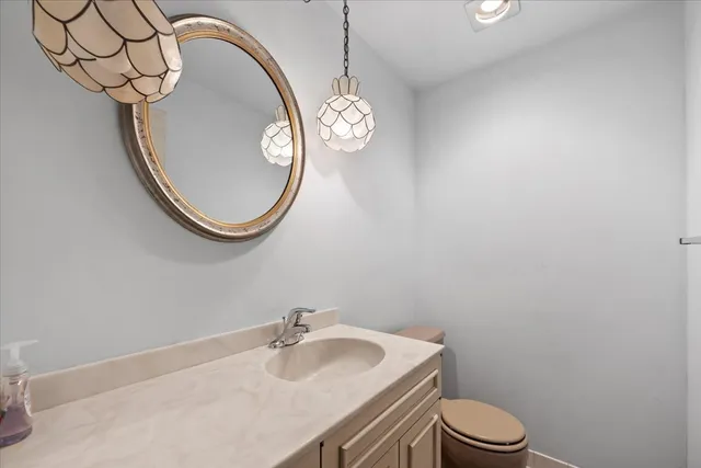 a view of a livingroom with furniture and chandelier fan