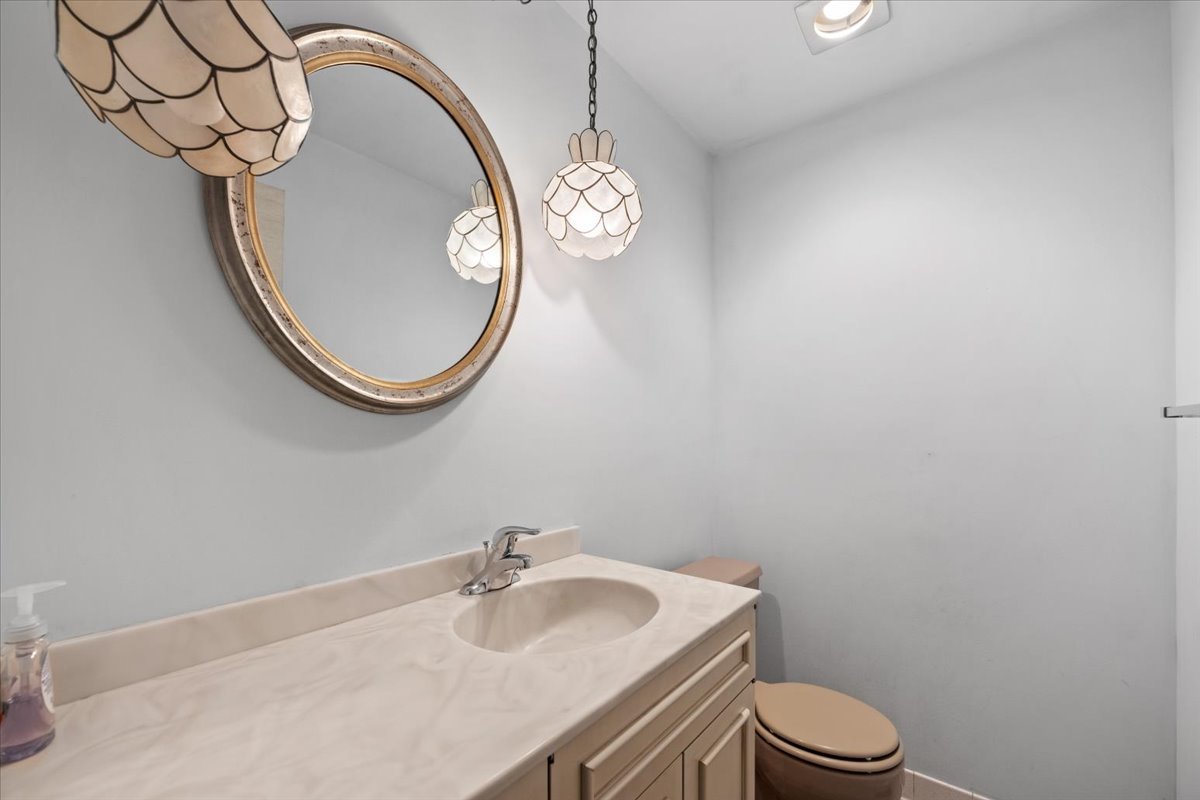 1730 West Galena Boulevard, Unit 402E Aurora, IL 60506 - Photo 17 of 26 a bathroom with a sink a toilet and a mirror