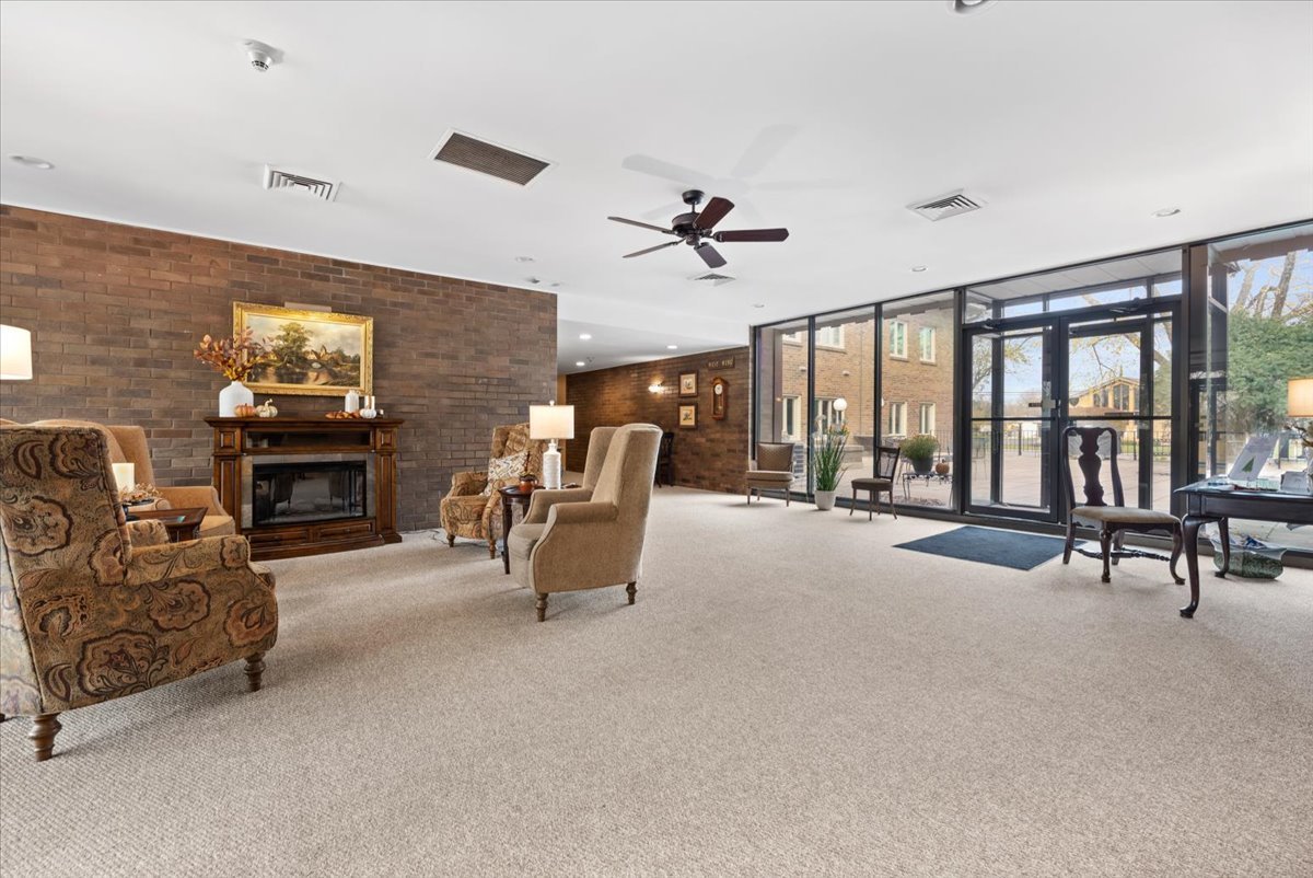 1730 West Galena Boulevard, Unit 402E Aurora, IL 60506 - Photo 4 of 26 a living room with furniture and a fireplace
