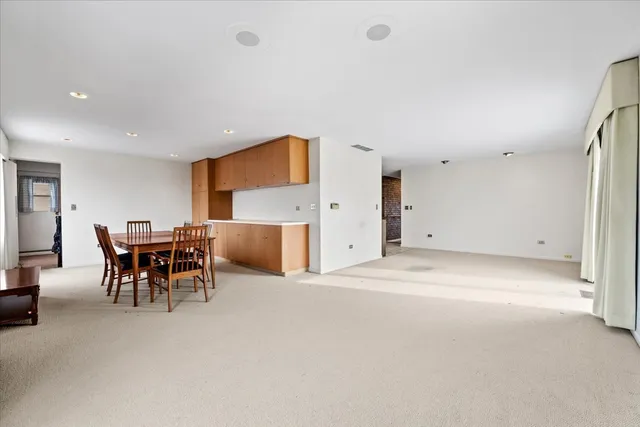 a view of a dining room with furniture and a chandelier