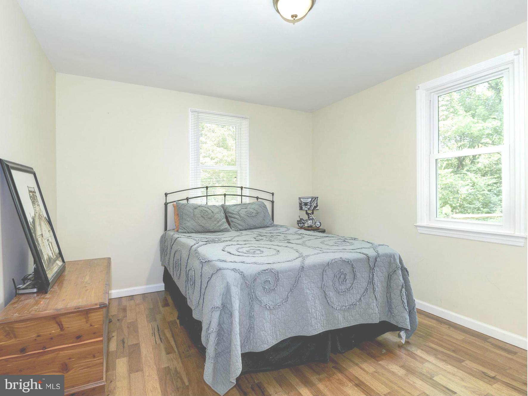 5301 Reels Mill Road Frederick, MD 21704 - Photo 14 of 22 a bedroom with a bed wooden floor and window