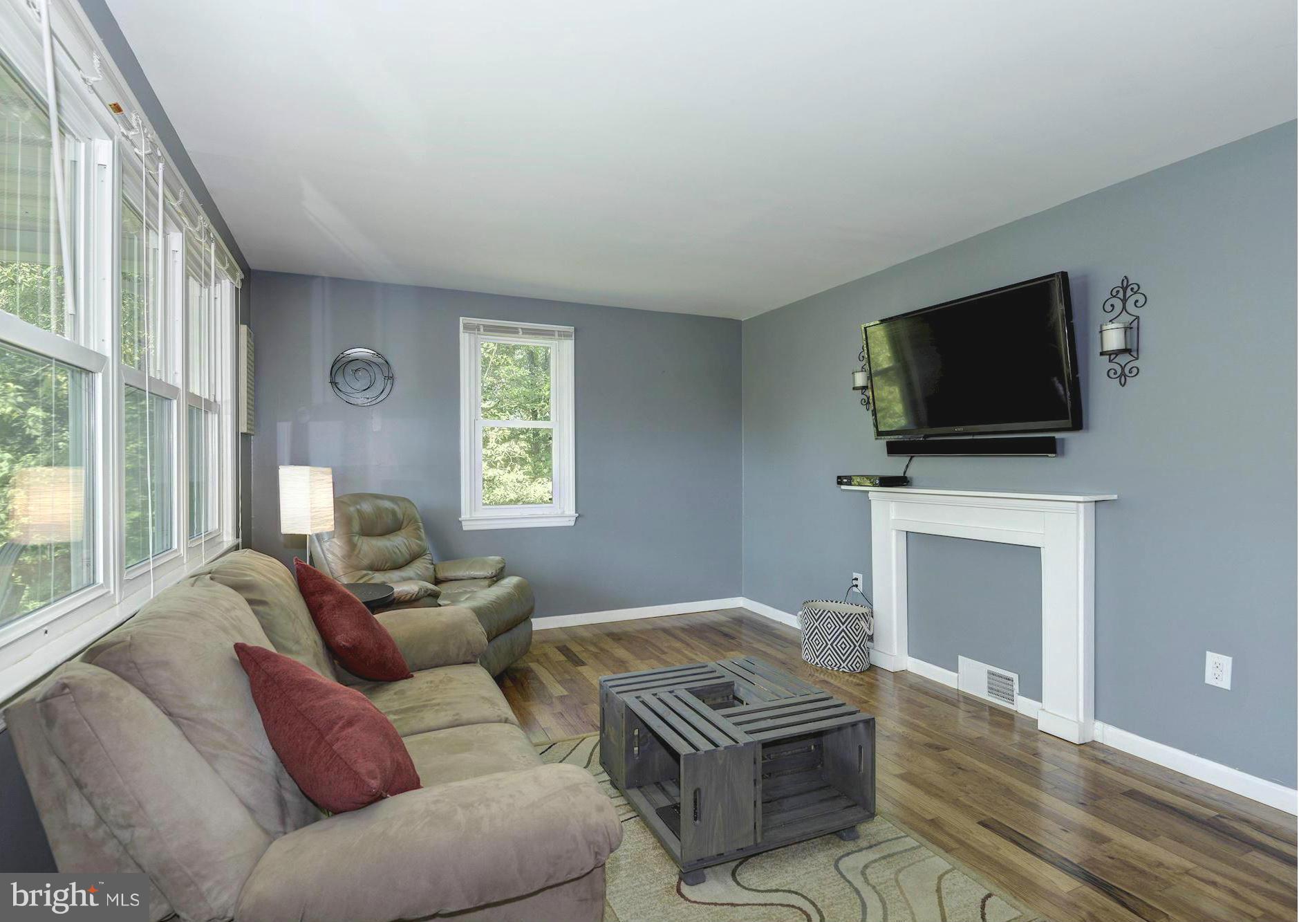 5301 Reels Mill Road Frederick, MD 21704 - Photo 4 of 22 a living room with furniture a fireplace and a flat screen tv