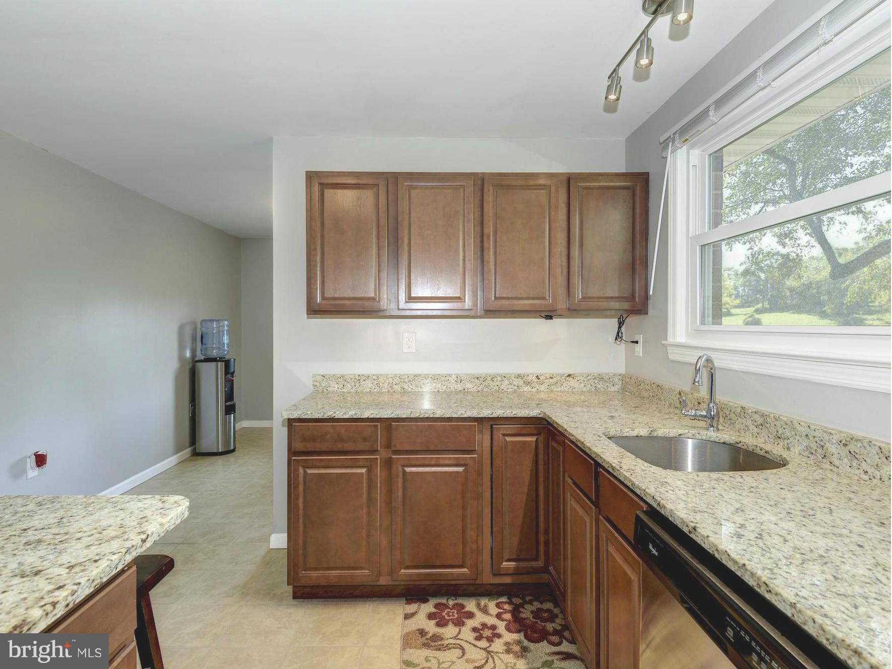 5301 Reels Mill Road Frederick, MD 21704 - Photo 8 of 22 a kitchen with a sink a window and cabinets