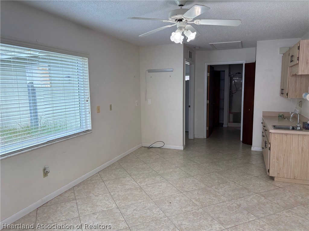 3913 Ferrari Drive Sebring, FL 33872 - Photo 16 of 20 a view of a livingroom with a chandelier fan and windows