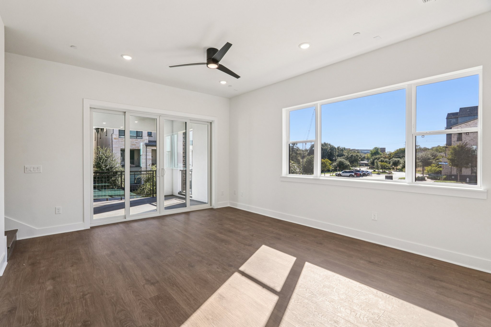 4311 Prevail Lane Austin, TX 78731 - Photo 11 of 40 a view of an empty room with a window and wooden floor