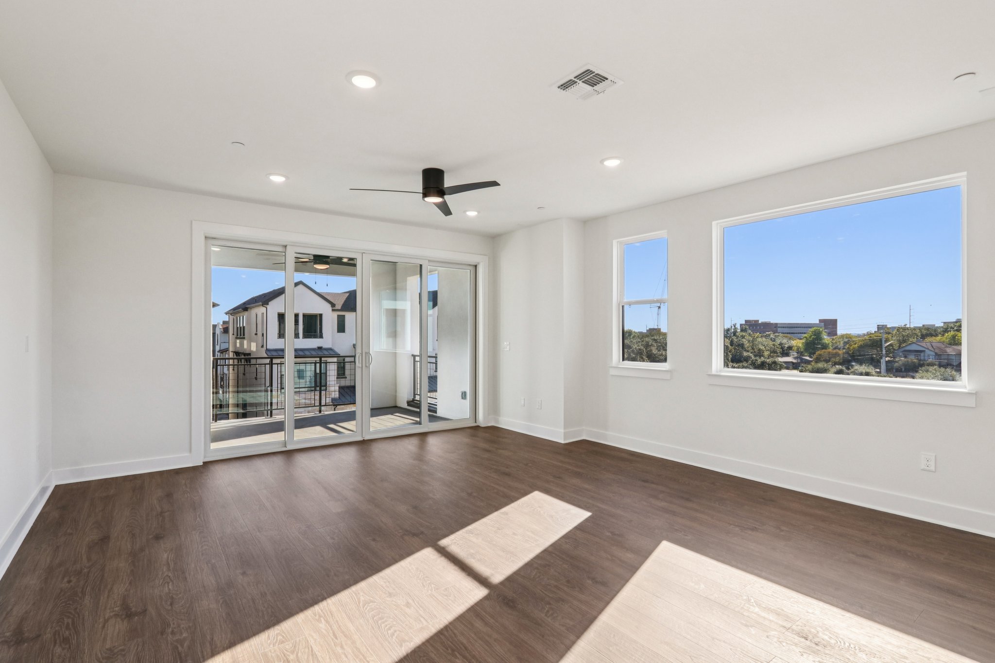 4311 Prevail Lane Austin, TX 78731 - Photo 12 of 40 a view of an empty room with wooden floor and a window