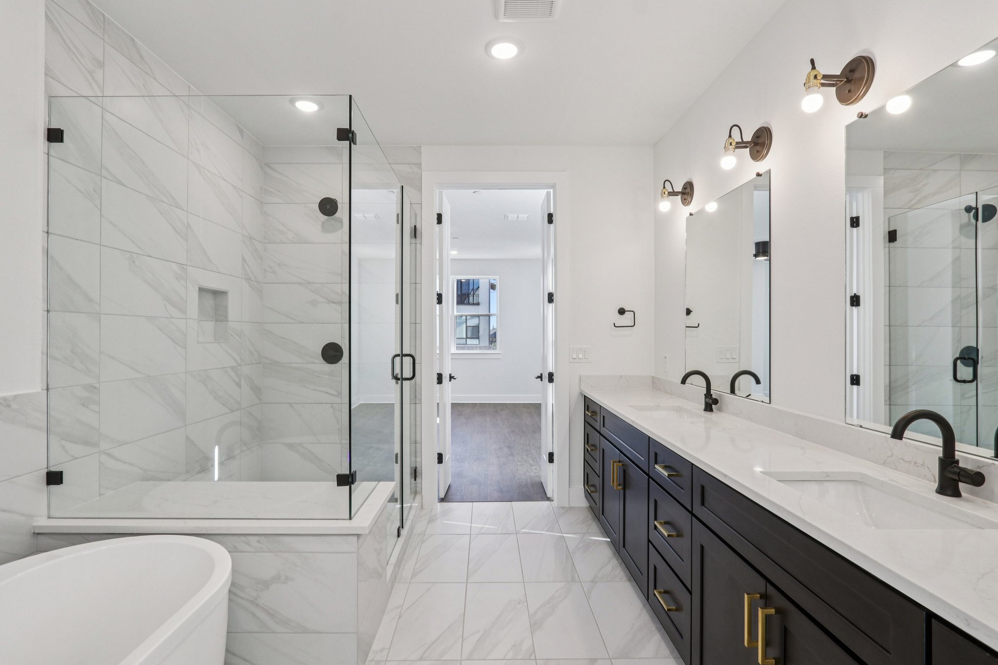 4311 Prevail Lane Austin, TX 78731 - Photo 17 of 40 a bathroom with a double vanity sink double mirror shower and a bathtub