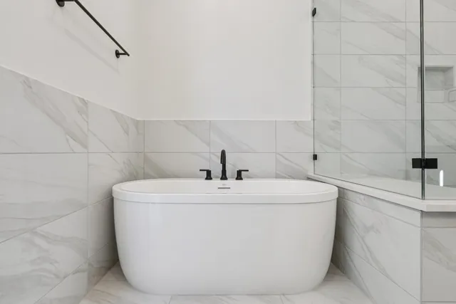 a white bath tub sitting in a bathroom
