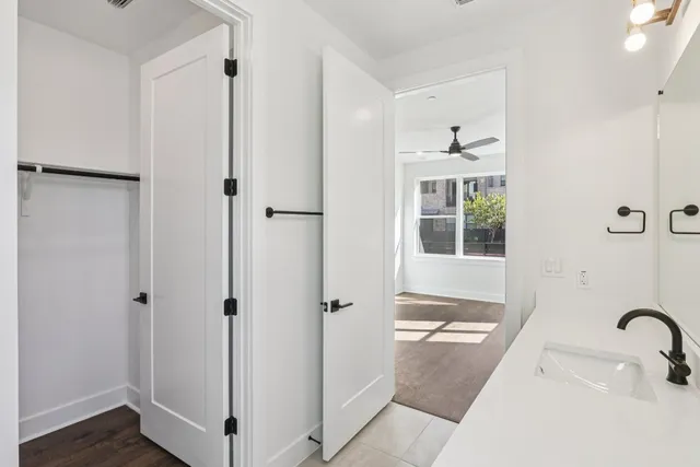 a bathroom with a tub shower and a sink