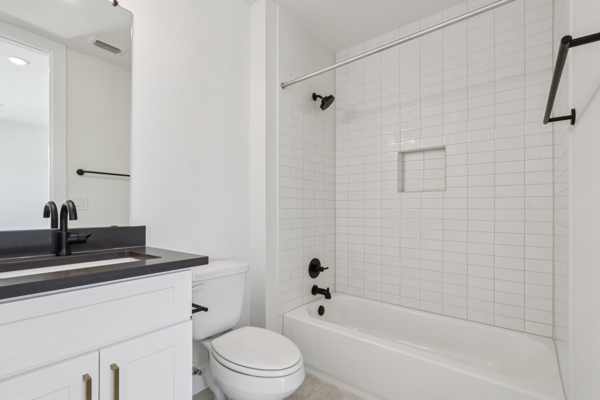 4311 Prevail Lane Austin, TX 78731 - Photo 27 of 40 a bathroom with a bathtub shower sink vanity and toilet