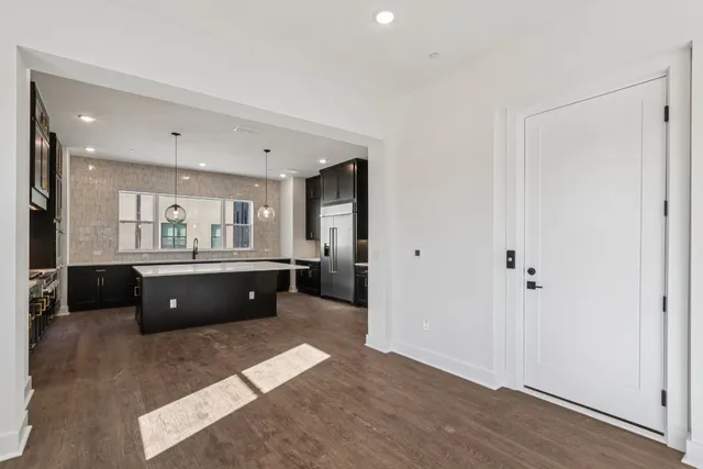 a living room with furniture a window and wooden floor