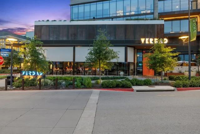 a front view of a house with a yard and a garage