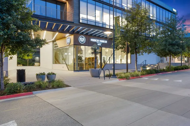 a view of a brick building with a street sign and a pathway