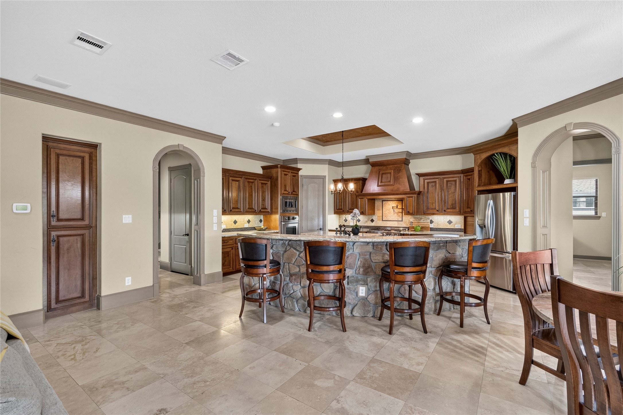 26 Post Shadow Estate Drive Spring, TX 77389 - Photo 17 of 49 This kitchen is a chef's dream with an oversized breakfast bar, commercial range, additional oven, separate vegetable sink and a plethora of cabinets and counter space
