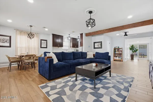 a living room with furniture and wooden floor