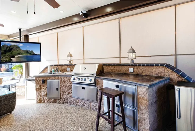 a kitchen with a stove a sink and cabinets