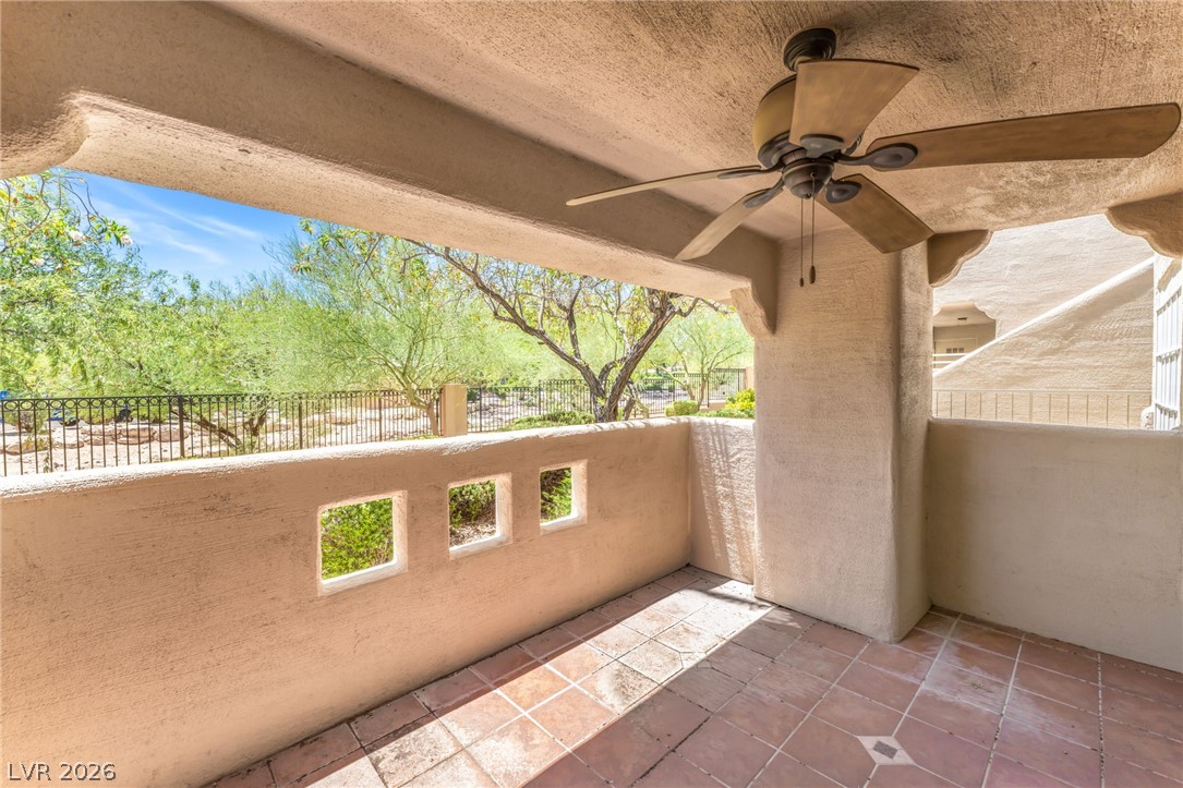 1901 Rio Canyon Court, Unit 102 Las Vegas, NV 89128 - Photo 20 of 23 A spacious covered patio offers comfortable outdoor living with a tiled floor and scenic views.