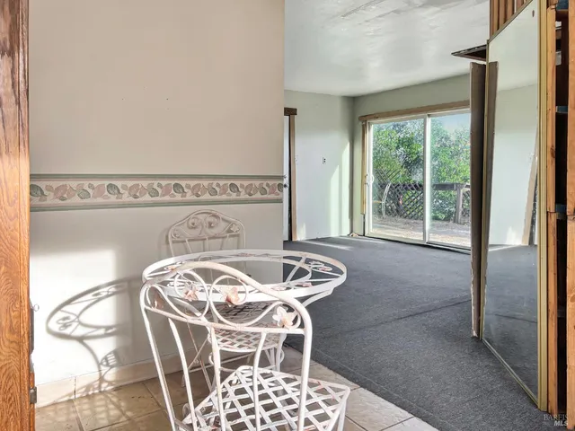 a view of a dining room with furniture and a window