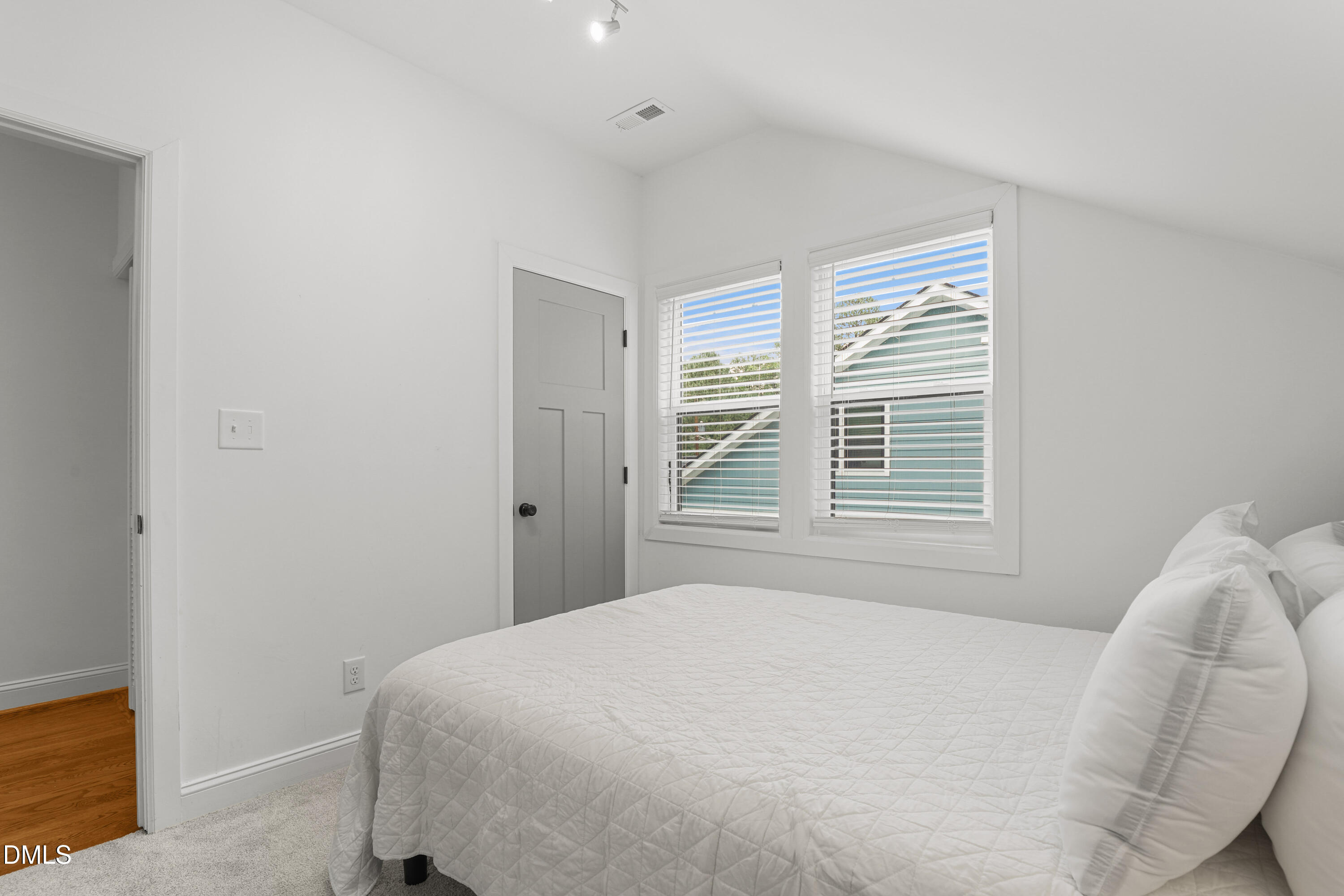 1217 Rosedale Avenue, Unit B Durham, NC 27707 - Photo 18 of 24 a bed sitting in a bedroom next to a window