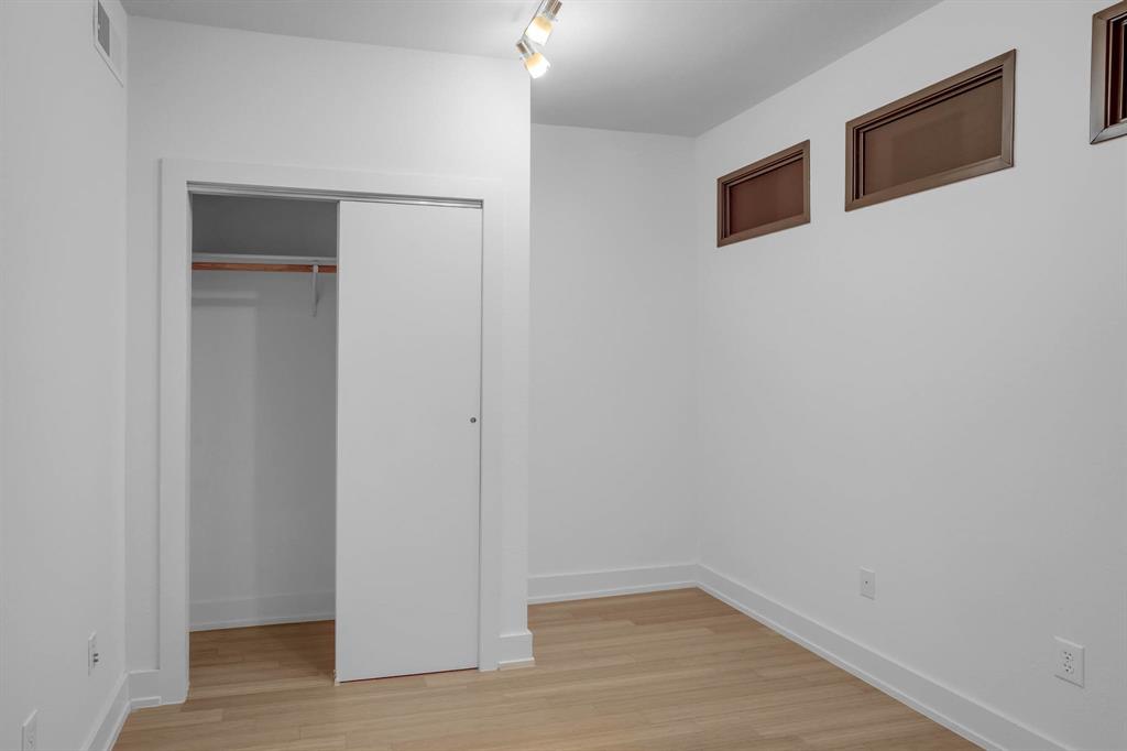 4333 Gilbert Avenue, Unit 215 Dallas, TX 75219 - Photo 13 of 19 a view of an empty room with wooden floor