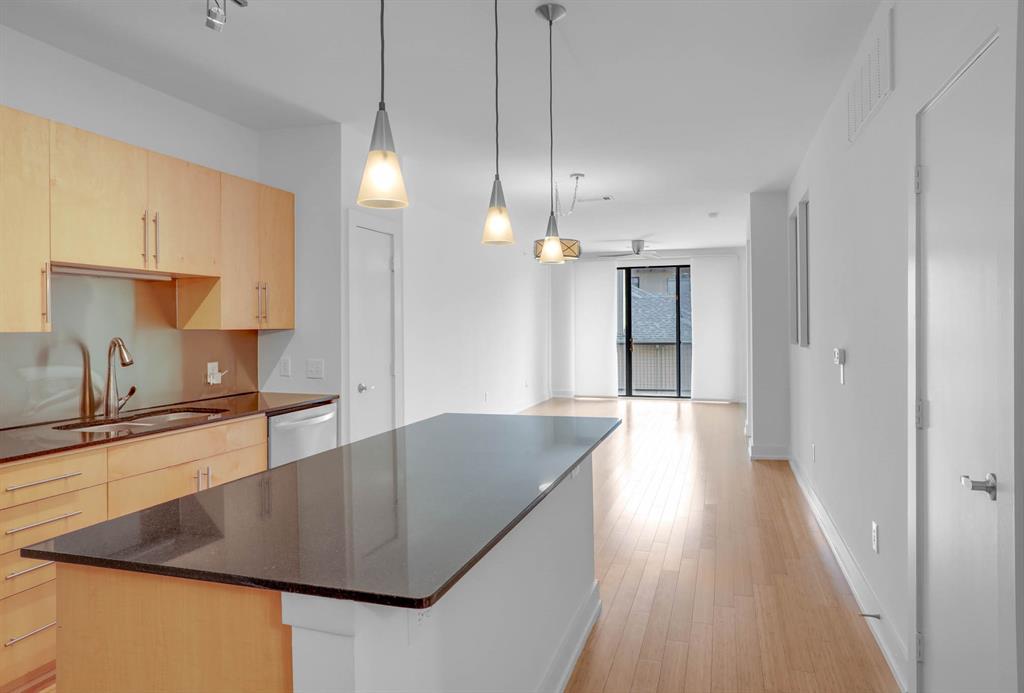 4333 Gilbert Avenue, Unit 215 Dallas, TX 75219 - Photo 3 of 19 a kitchen with stainless steel appliances granite countertop a sink a stove and a wooden floors