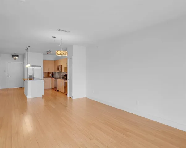 a view of a kitchen with furniture and wooden floor