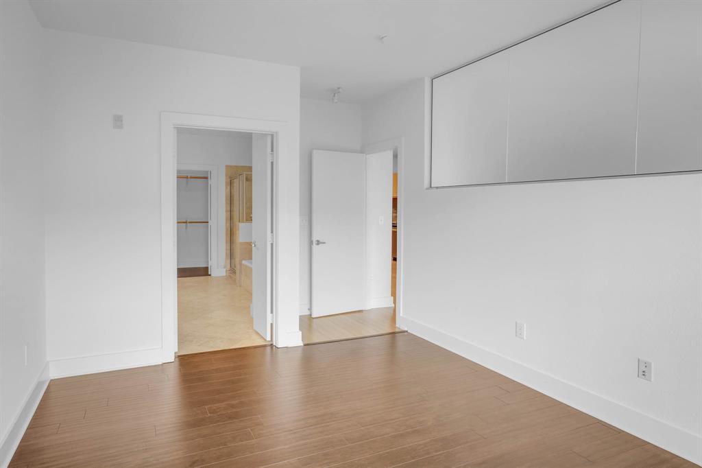 4333 Gilbert Avenue, Unit 215 Dallas, TX 75219 - Photo 9 of 19 a view of an empty room with wooden floor and closet