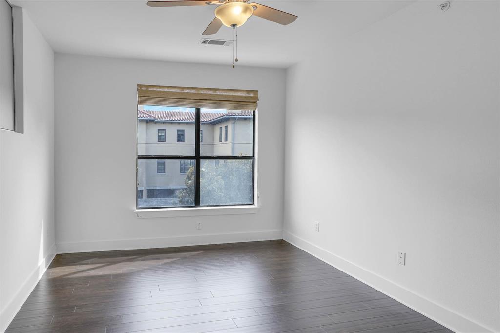 4333 Gilbert Avenue, Unit 215 Dallas, TX 75219 - Photo 10 of 19 an empty room with wooden floor chandelier and windows