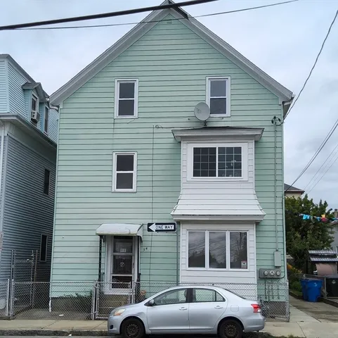 a front view of a house with a parking space