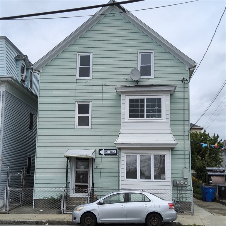 a front view of a house with a parking space
