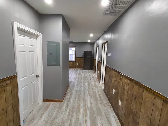 a view of hallway with wooden floor