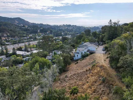 a view of a dirt road with a building in the background