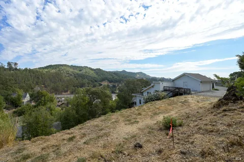 a view of a house with a backyard