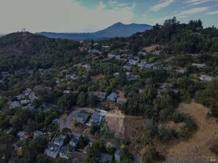an aerial view of a city and mountain view in back