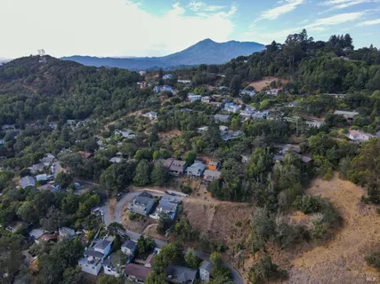 an aerial view of a house with a yard