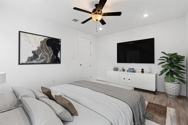 a bedroom with a bed and a flat screen tv