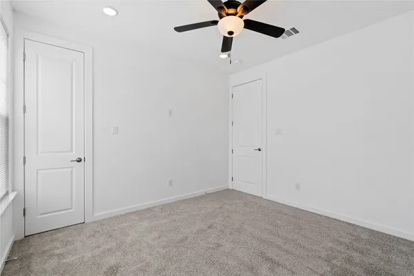 an empty room with a fan
