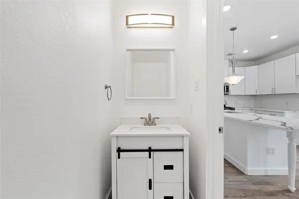 a bathroom with a sink a vanity and a mirror
