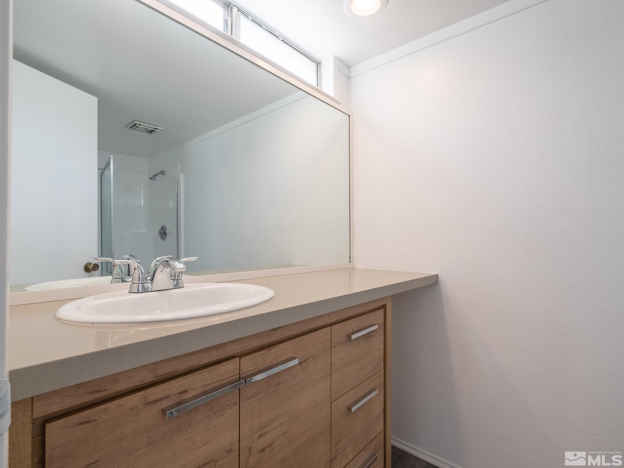 15025 Perlite Drive Reno, NV 89521 - Photo 17 of 24 a bathroom with a sink and a mirror