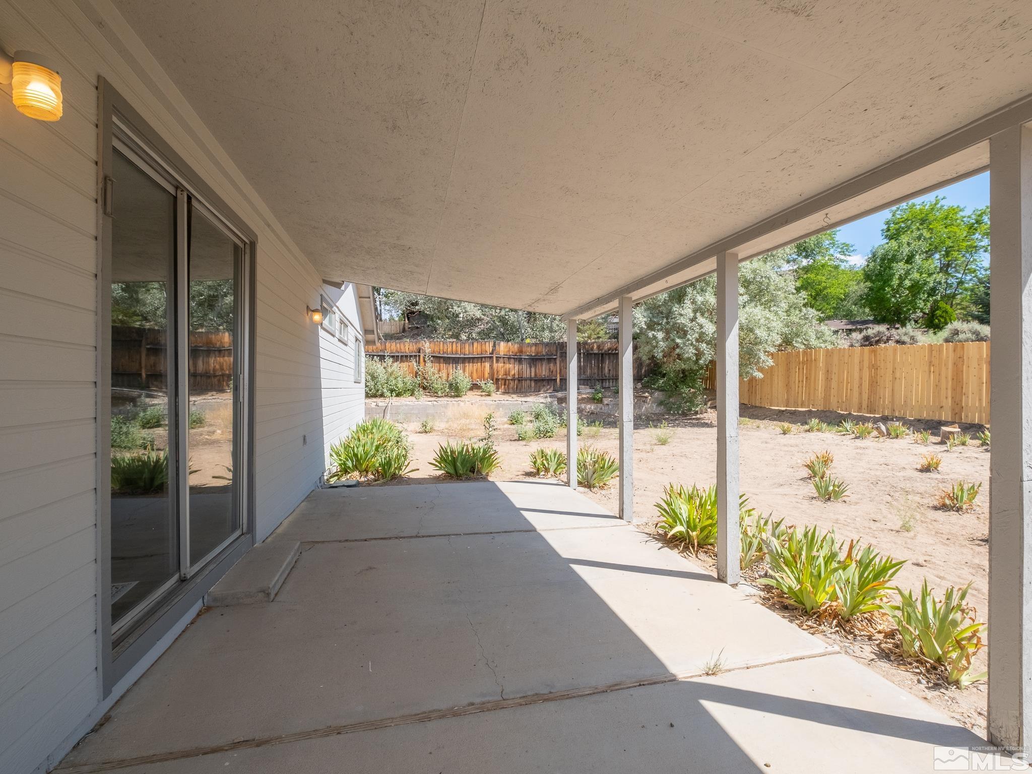 15025 Perlite Drive Reno, NV 89521 - Photo 19 of 24 a view of porch with a floor to ceiling window next to a yard