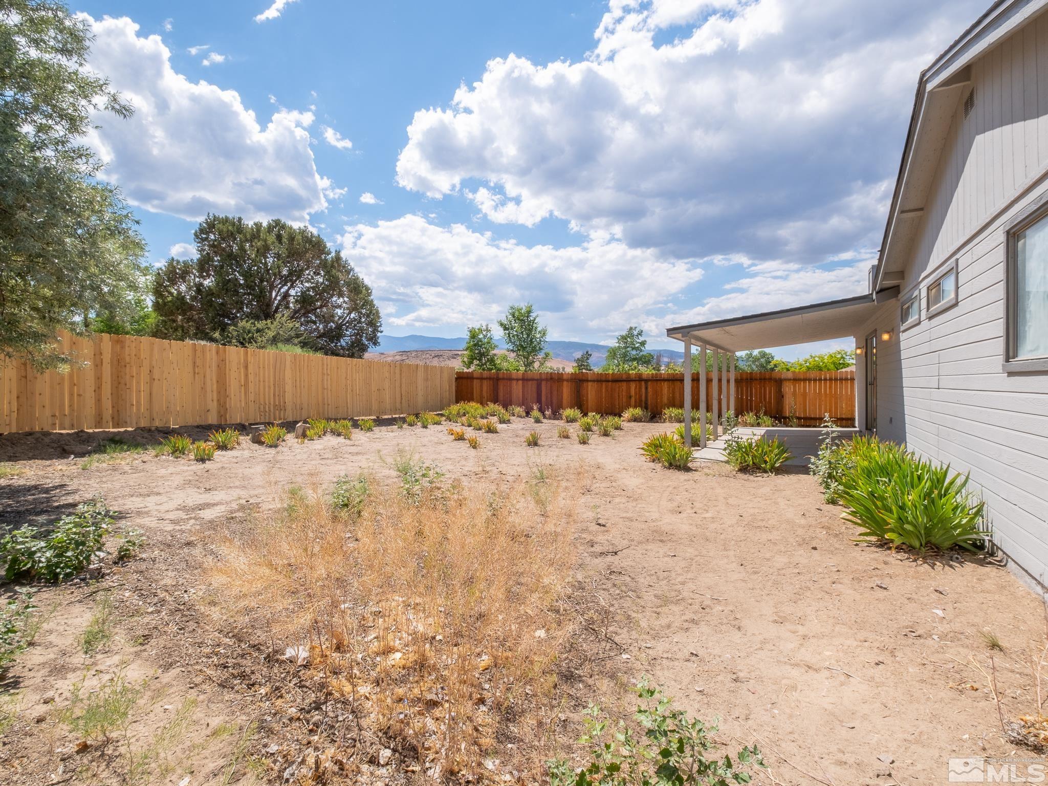 15025 Perlite Drive Reno, NV 89521 - Photo 20 of 24 a front view of a house with a yard and trees