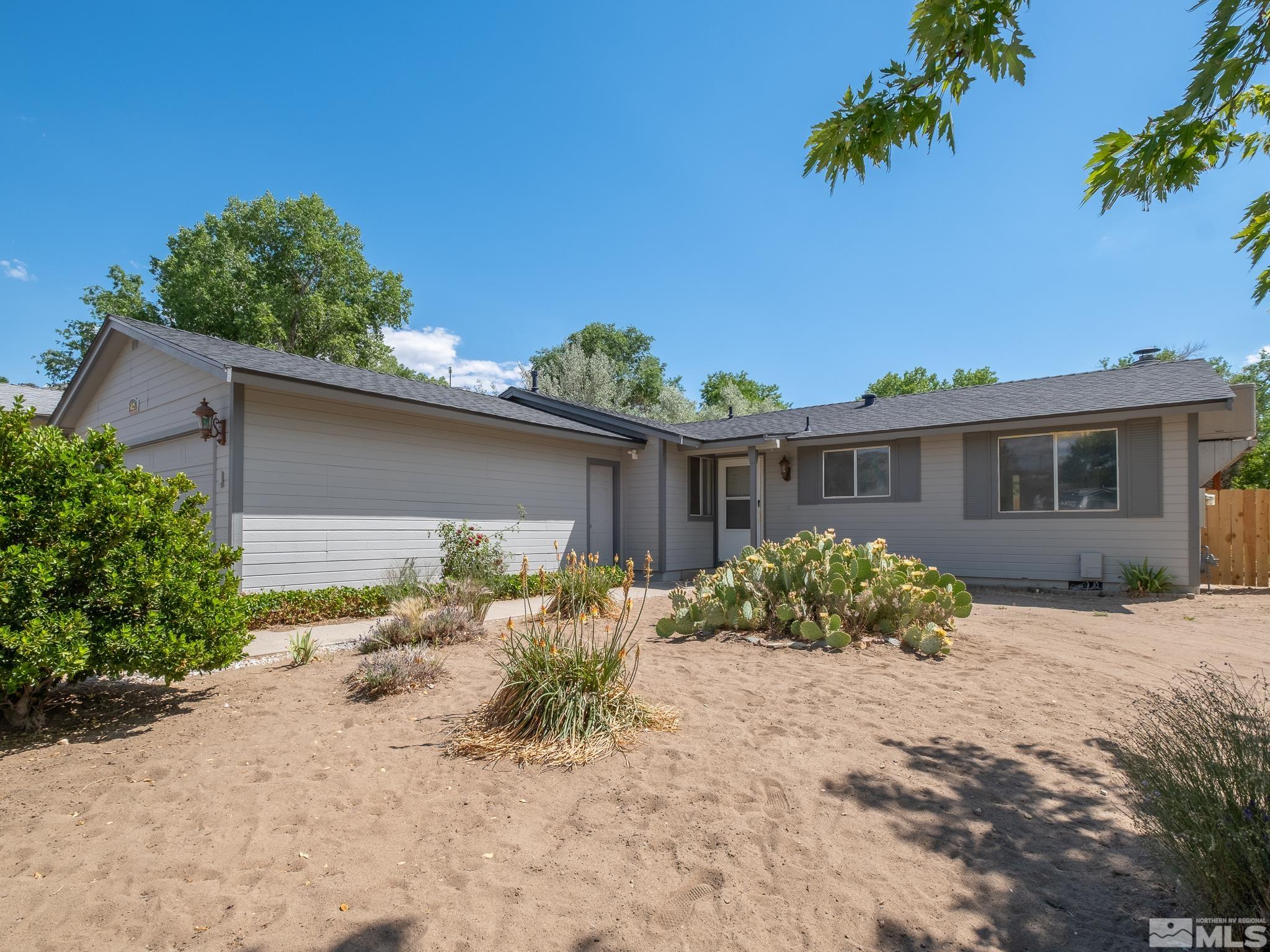 15025 Perlite Drive Reno, NV 89521 - Photo 2 of 24 a front view of house with yard and trees around