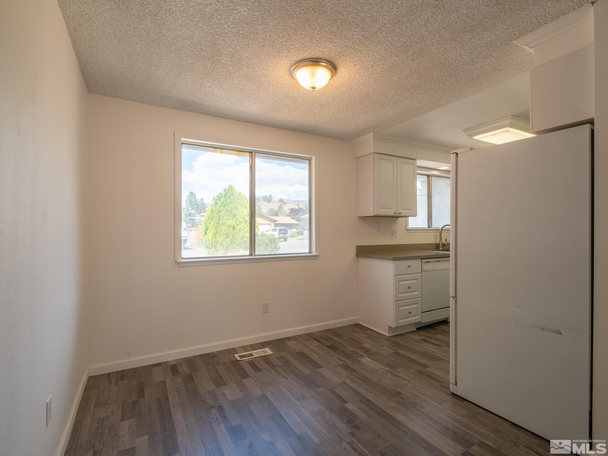 15025 Perlite Drive Reno, NV 89521 - Photo 23 of 24 wooden floor in an empty room with a window