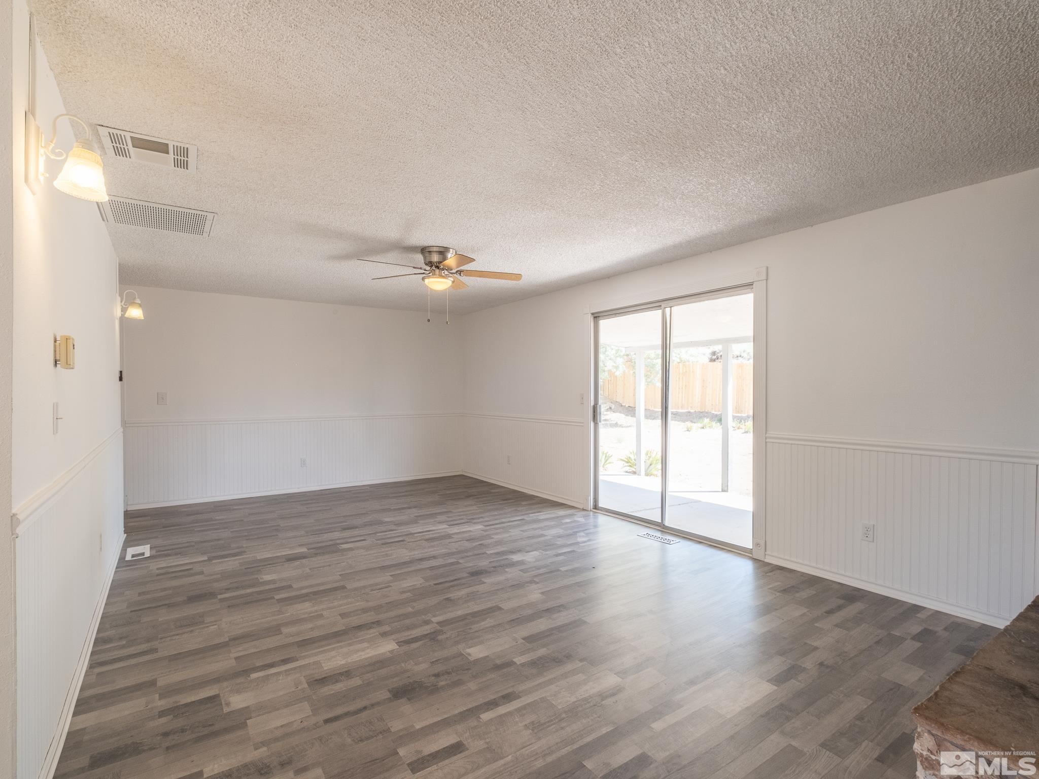 15025 Perlite Drive Reno, NV 89521 - Photo 5 of 24 a view of an empty room with wooden floor and a window