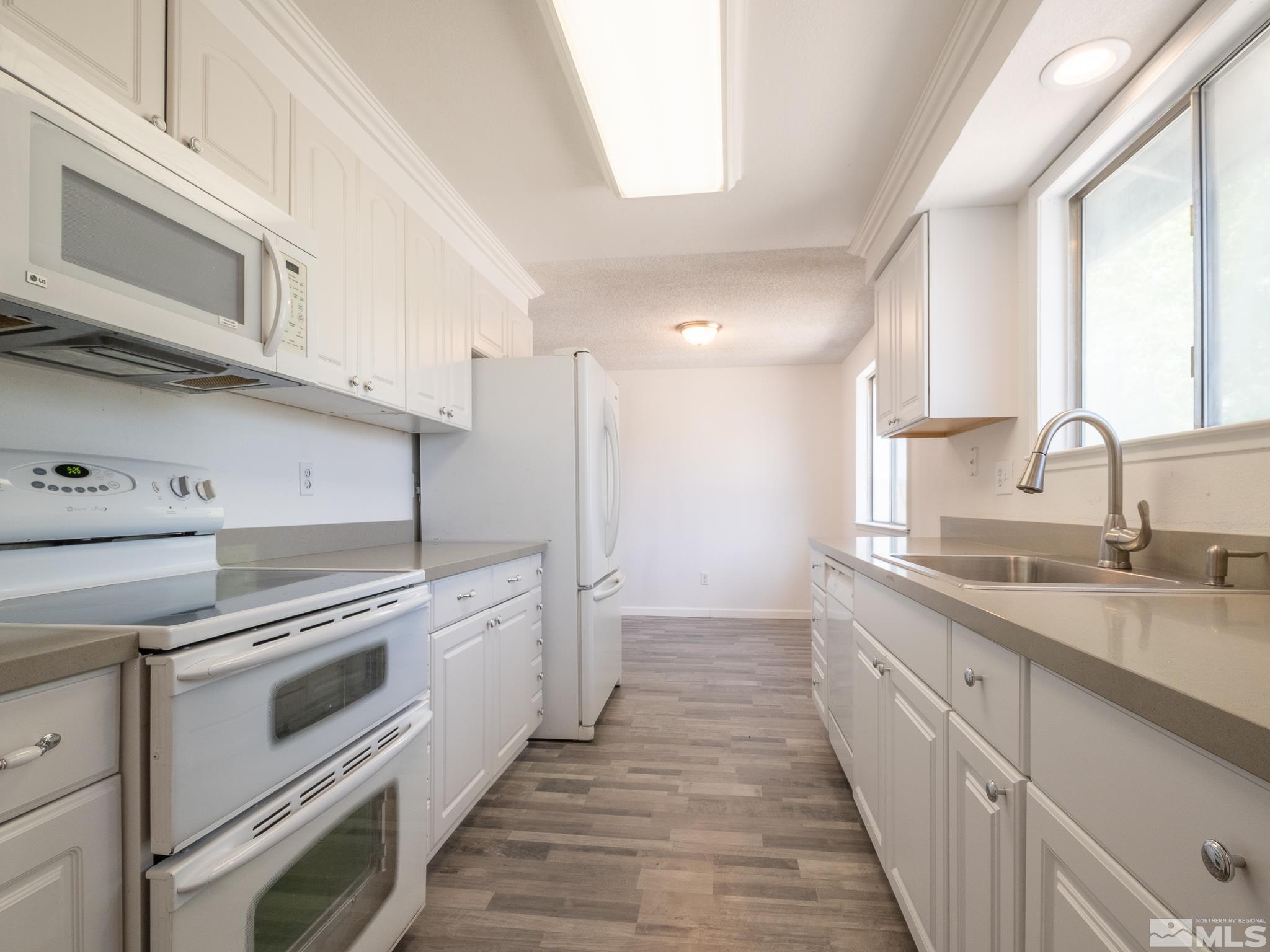 15025 Perlite Drive Reno, NV 89521 - Photo 6 of 24 a kitchen with a sink stove and cabinets